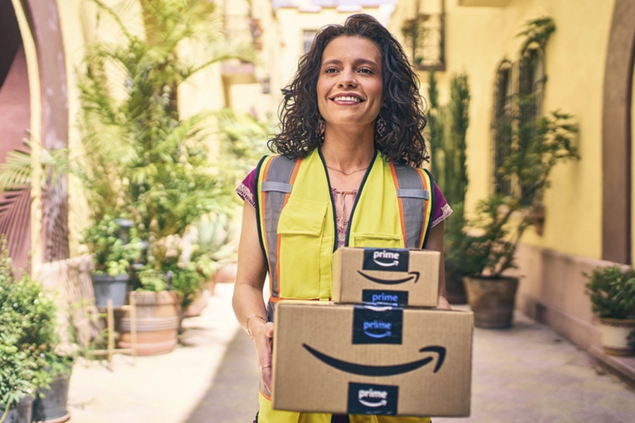 woman in yellow vest carrying a package
